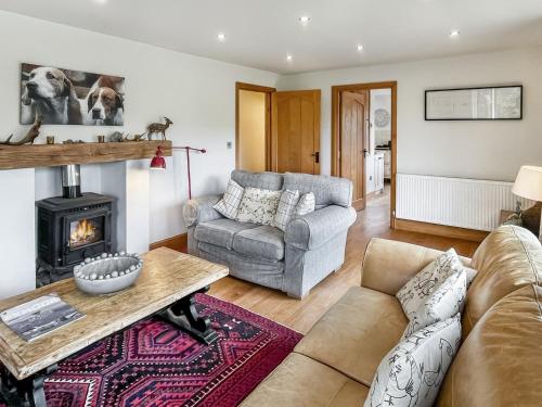 a living room with a couch and a fireplace at Ormrods in Withypool