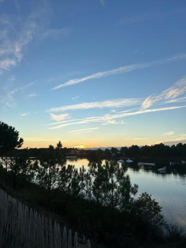 a view of a river at sunset at Studio Neuf à 2 pas de la plage in La Tranche-sur-Mer