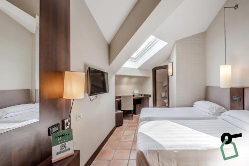 Postel nebo postele na pokoji v ubytování HOTIDAY Room Collection - Roma Cornelia