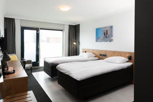 Hotel Keyser Bredaにあるベッド