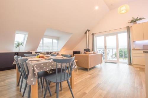 a kitchen and dining room with a table and chairs at Melfort Pier & Harbour Resort in Kilmelfort