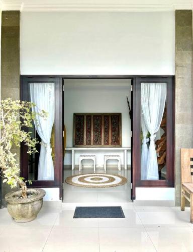 an open door of a house with a courtyard at Canggu Surf Villa in Canggu