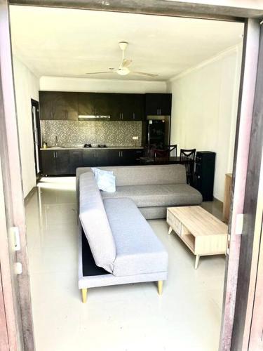 a living room with a couch and a coffee table at Canggu Surf Villa in Canggu