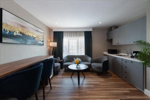 a kitchen and living room with a table and chairs at Warwick Al Jubail Hotel in Al Jubail