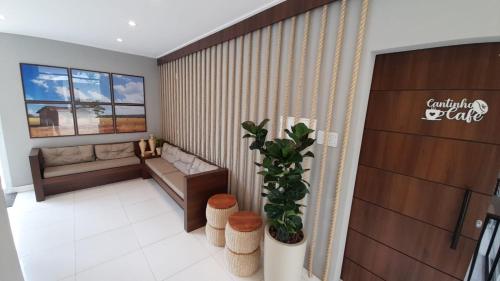 a living room with a couch and a window at NOVO HOTEL in Conceição do Coité