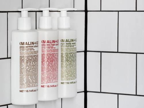 a group of three white bottles on a white tiled wall at Graduate by Hilton Iowa City in Iowa City