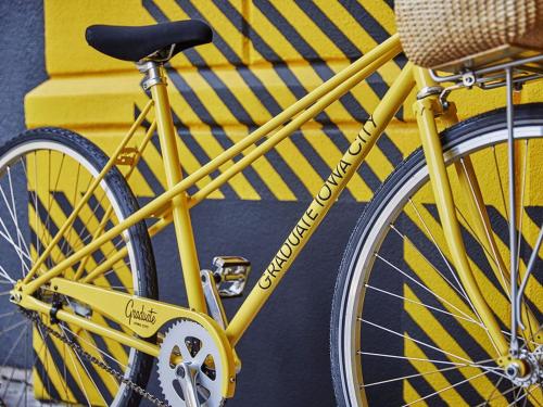 a yellow bike parked next to a yellow wall at Graduate by Hilton Iowa City in Iowa City