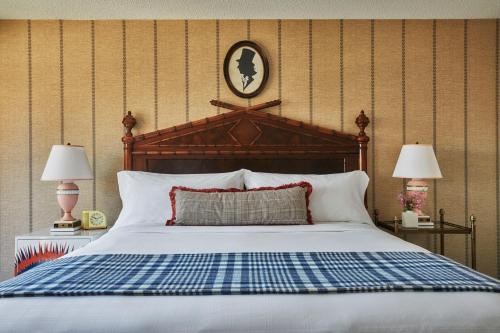 a bedroom with a bed with a blue and white blanket at Graduate by Hilton Iowa City in Iowa City