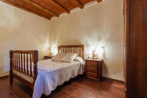 a bedroom with a bed and a nightstand and a bed sidx sidx sidx sidx at Rural Mas Vila in Fogás de Tordera
