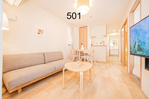 a living room with a couch and a table at Newly build Family-APT , Shinjuku Shibuya Ueno in 15 minutes by train in Tokyo