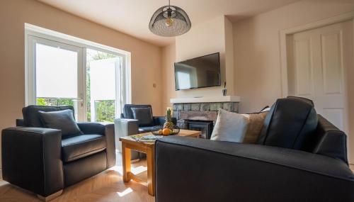 a living room with a couch and chairs and a table at Newby Bridge Country Caravan Park in Newby Bridge