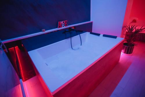 a ping pong table in a room with red and blue lights at Suite La PerlaNera- TorreCanne in Torre Canne