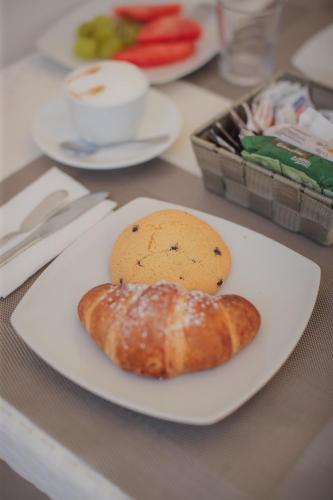 a plate of food with a pastry on a table at Suite La PerlaNera- TorreCanne in Torre Canne