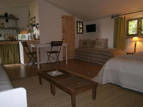 a living room with a bed and a couch at A la campagne in Champagné-Saint-Hilaire