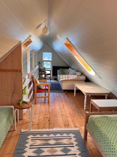a living room with a couch and a table at Cottage by the waterfront in Vestmanna