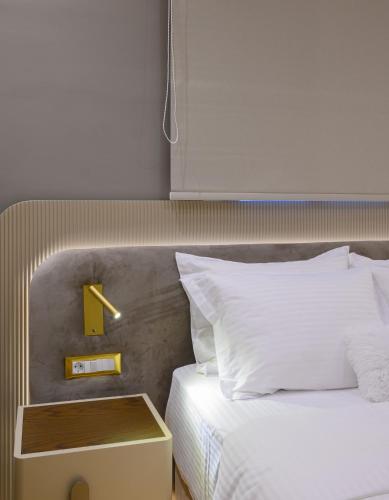 a bedroom with a bed and a night stand next to it at The Zorbas Apartments in Mytilini