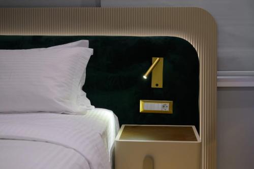 a hotel room with a bed with a number one on it at The Zorbas Apartments in Mytilini