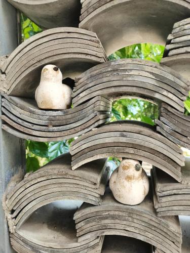 two birds sitting on top of some books at XiXi Lakeside Inn in Guilin