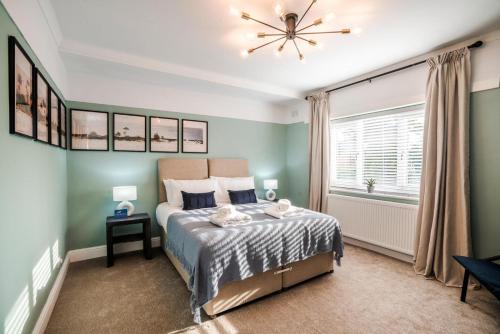 a bedroom with a bed and a window at The Coach House 3 bed apartment with off-street parking in Ellesmere Port in Ellesmere Port