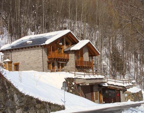 a house with snow on the roof at Artemisia Eco-Pet friendly B&B in La Salle
