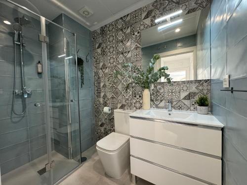 a bathroom with a toilet and a sink and a shower at Navas 202 Elegant Suite in Granada