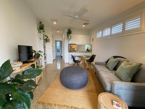 a living room with a couch and a table at East Woonona Sea Esta Studio in Woonona