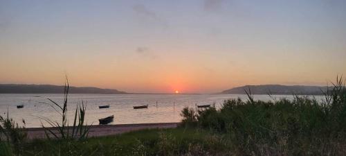a group of boats in the water at sunset at Casa do Alto in Nadadouro