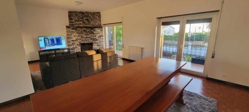 a living room with a couch and a fireplace at Casa do Alto in Nadadouro