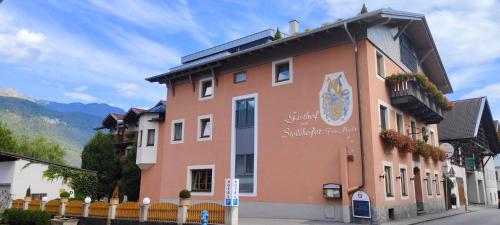 a building with a sign on the side of it at Gasthof Zum Stollhofer in Inzing