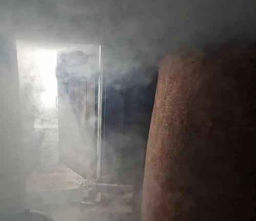 a door in the middle of a building in the fog at An authentic granary in Bilioniai