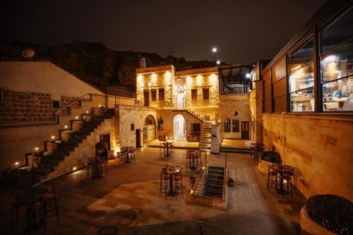 een gebouw met stoelen en tafels op een binnenplaats 's nachts bij Misty Cave Hotel in Urgup