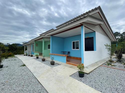a house with blue and green paint on it at Suansubtawee Resort in Ban Baketa