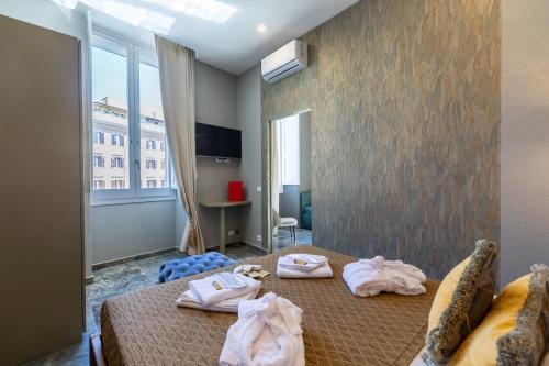 a bedroom with a bed with towels on it at Piazza di Spagna 51 Luxury guest house in Rome