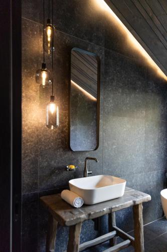 a bathroom with a sink and a mirror at Paznauner Villen - Villa I in Kappl