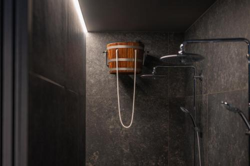 a shower with a bucket on the wall in a bathroom at Paznauner Villen - Villa I in Kappl