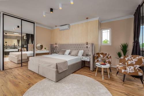 a bedroom with a large bed and a bathroom at Villa Lea ZadarVillas in Zaton