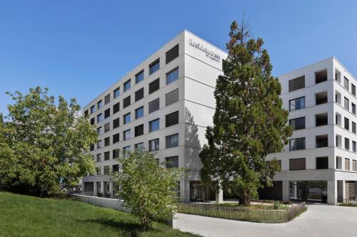 an office building with a tree in front of it at Residence Inn by Marriott Geneva City Nations in Geneva