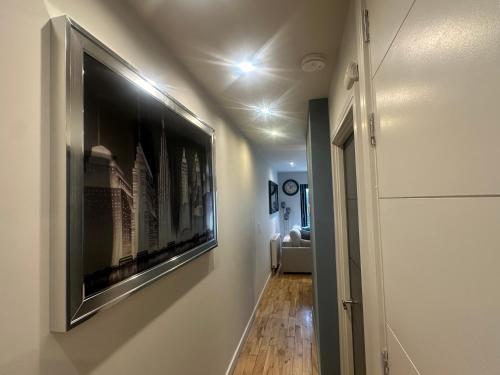 a hallway with a large flat screen tv on the wall at Oakfield Premier Apartments-High Speed WiFi-Smart SelfCheckIn-Central Cardiff Gem in Cardiff