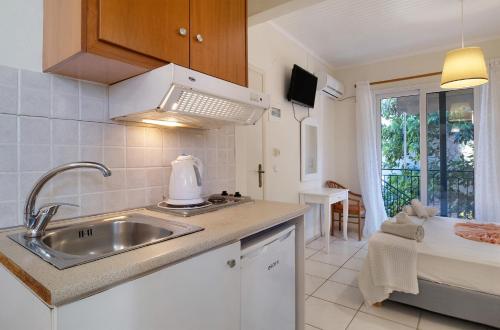 a kitchen with a sink and a counter top at S6 apartment in Nikiana