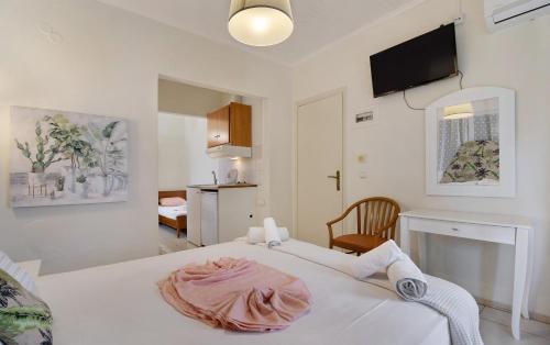 a bedroom with a bed with a towel on it at S6 apartment in Nikiana