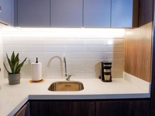 a kitchen counter with a sink and a candle at Art Homes 85 in Bogotá