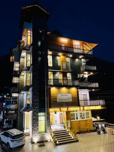a building with a car parked in front of it at The Crown in Dharamshala