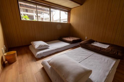 Postel nebo postele na pokoji v ubytování 永楽町House