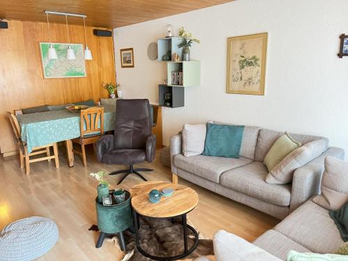 a living room with a couch and a table at Your home in Mürren near the ski slopes and hiking trails in Mürren