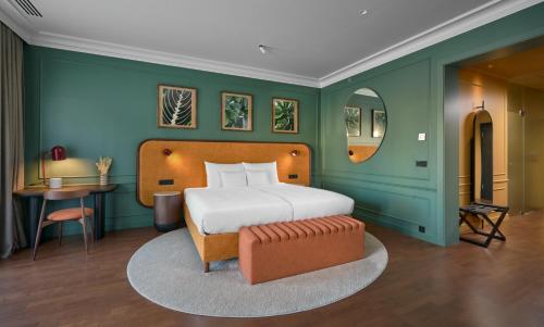 a bedroom with a bed and a chair and a table at Verno House Budapest, Vignette Collection by IHG in Budapest