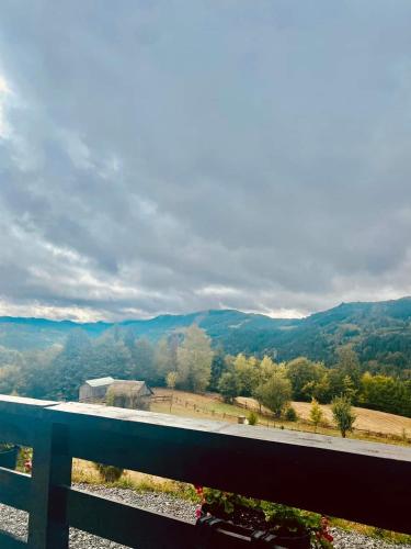 a view of the mountains from the balcony of a house at Pensiunea Agroturistica Acvila Apusenilor in Vadu Moţilor