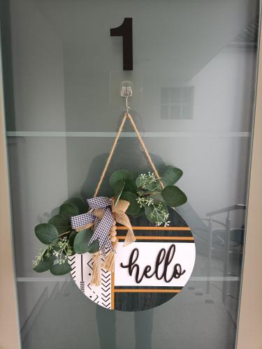 a sign that says hello with a potted plant at Nationalpark Apartments in Apetlon