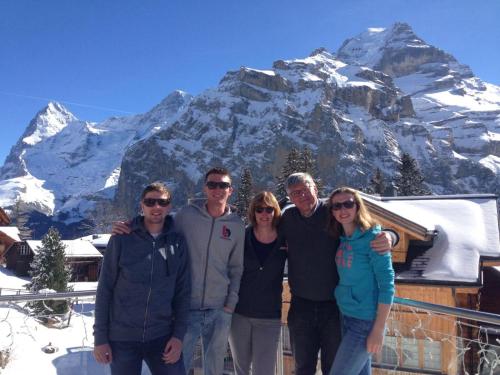 a group of people standing in front of a mountain at Your home in Mürren near the ski slopes and hiking trails in Mürren