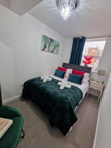 a bedroom with a bed with two teddy bears on it at 12 B Market Street in Watford