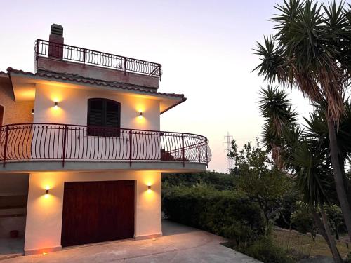 a house with a balcony on top of it at Suite - Villa La Terrazza Sul Mare in Trabia